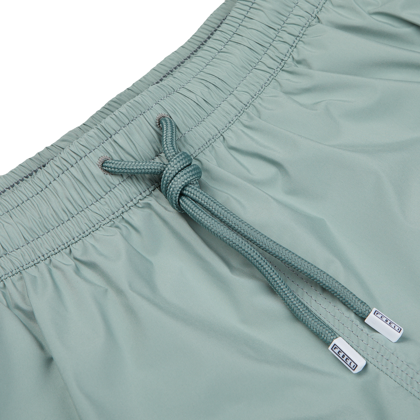 Close-up of a teal drawstring on Fedeli Sage Green Madeira Microfiber Swim Shorts with visible brand tags.