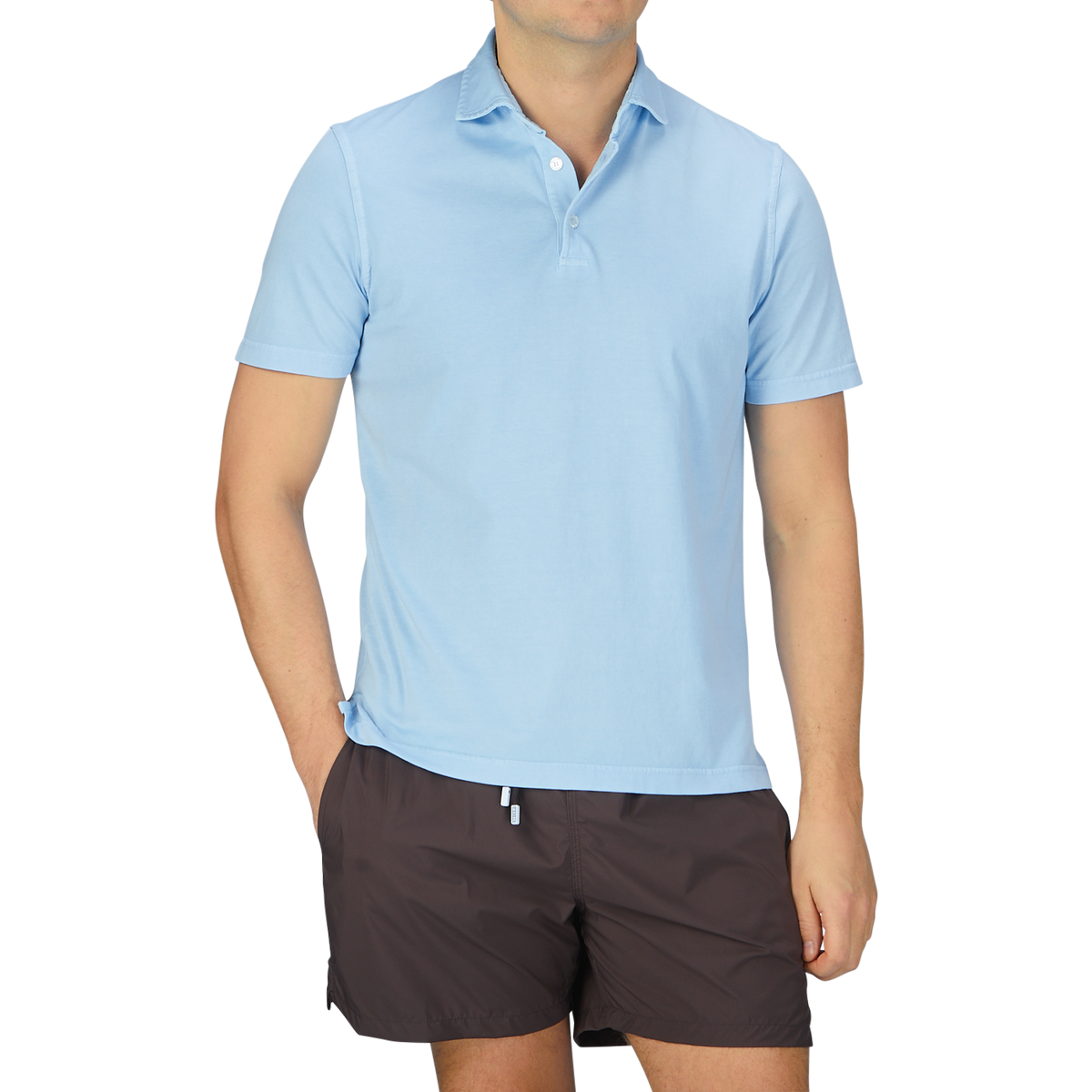 A man wearing a luxury Fedeli Sky Blue Organic Cotton Polo Shirt.