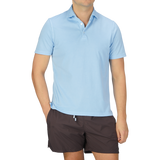 A man wearing a luxury Fedeli Sky Blue Organic Cotton Polo Shirt.
