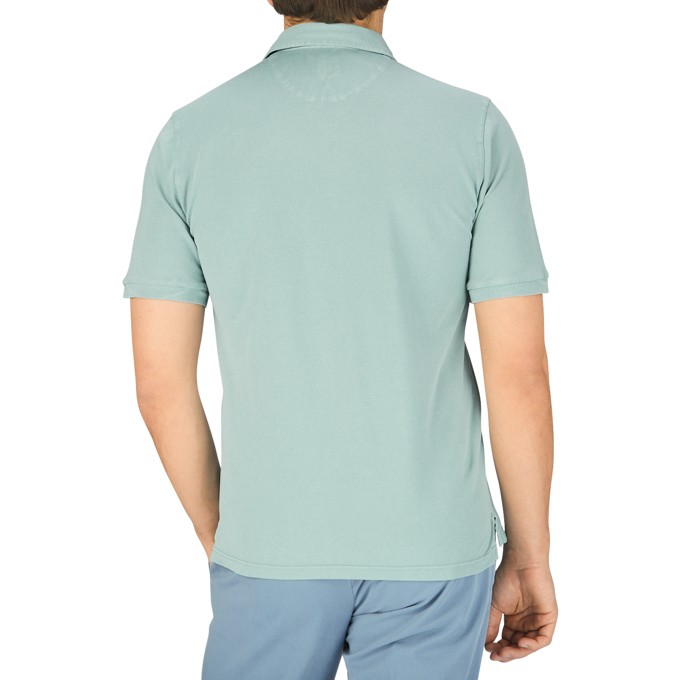 The back view of a man wearing a Fedeli Washed Light Green Cotton Pique Polo Shirt.