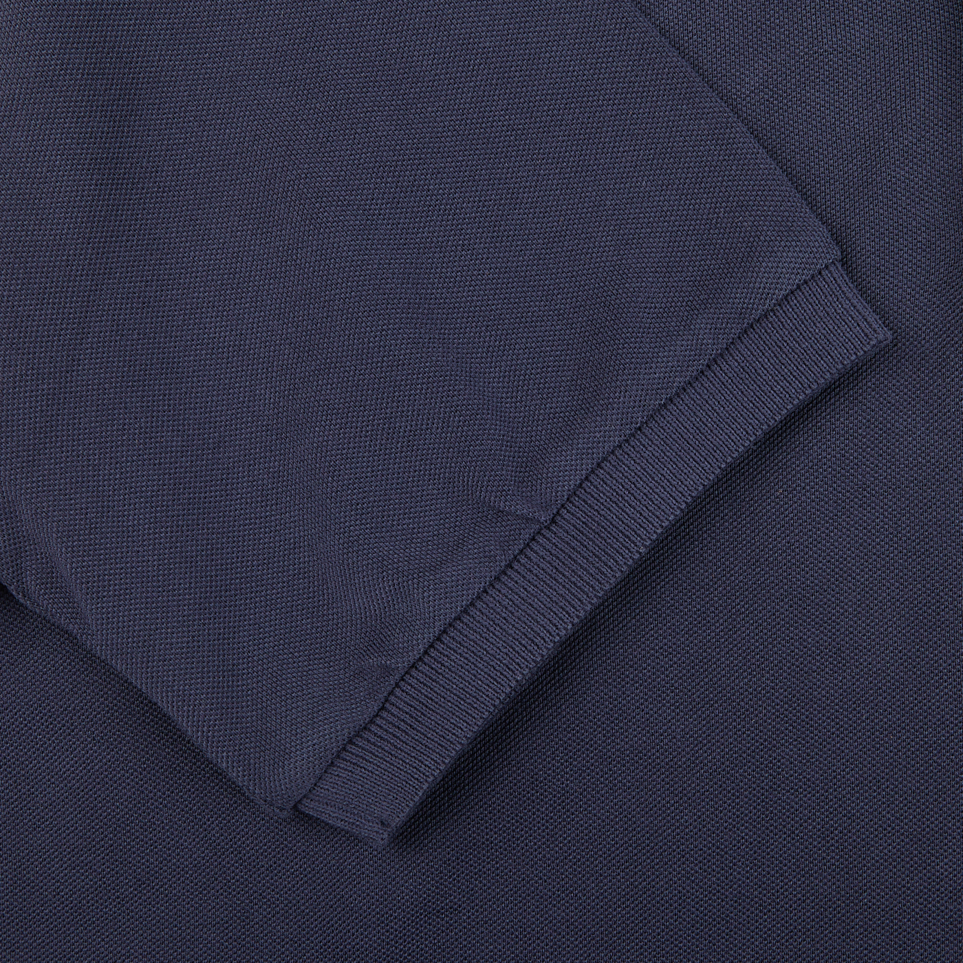 A close up of a navy **Fedeli Washed Navy Cotton Pique Polo Shirt**.