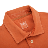 The back of a Washed Rust Cotton Pique Polo Shirt by Fedeli with a label on it.