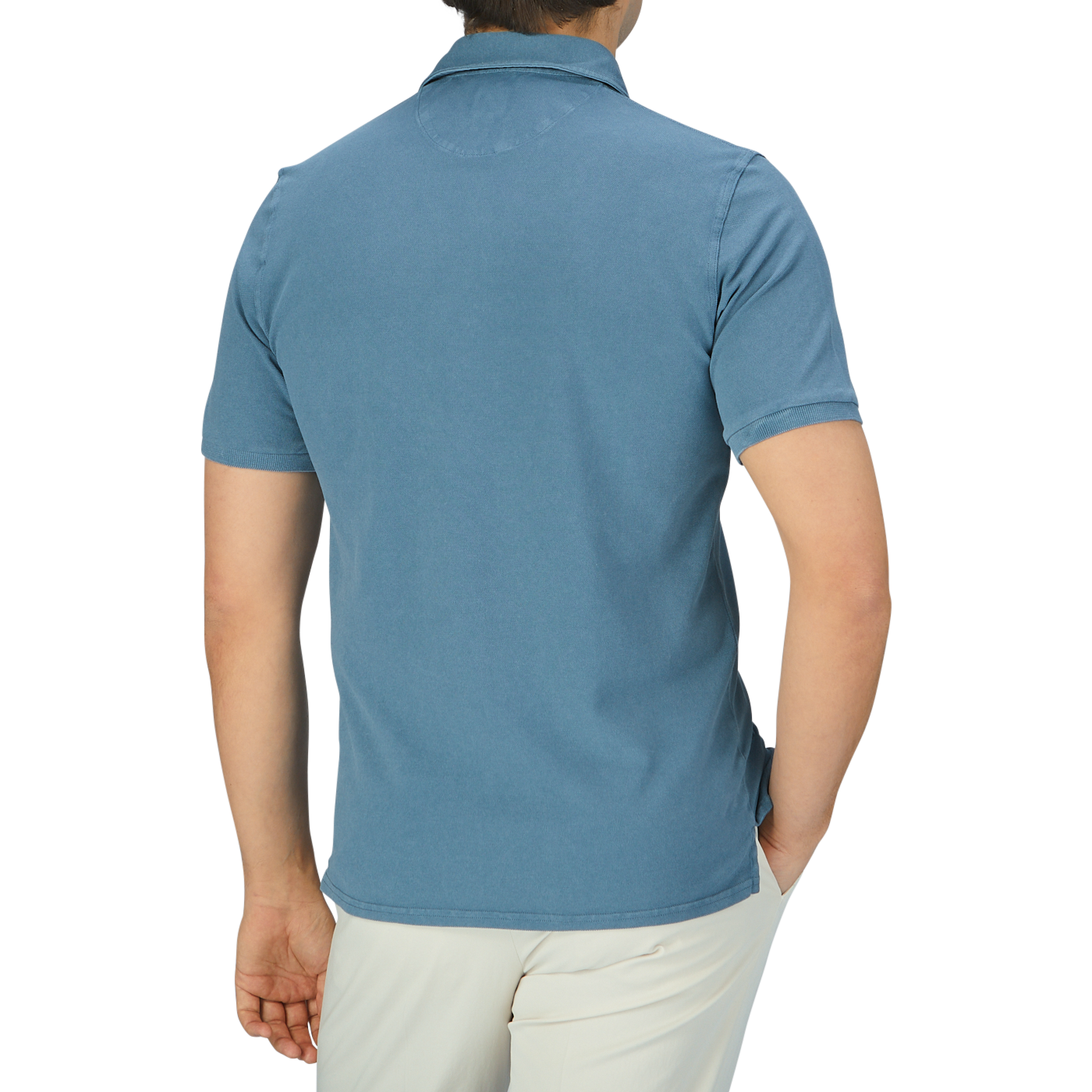 The back view of a man wearing a Fedeli Washed Turquoise Cotton Pique Polo Shirt.