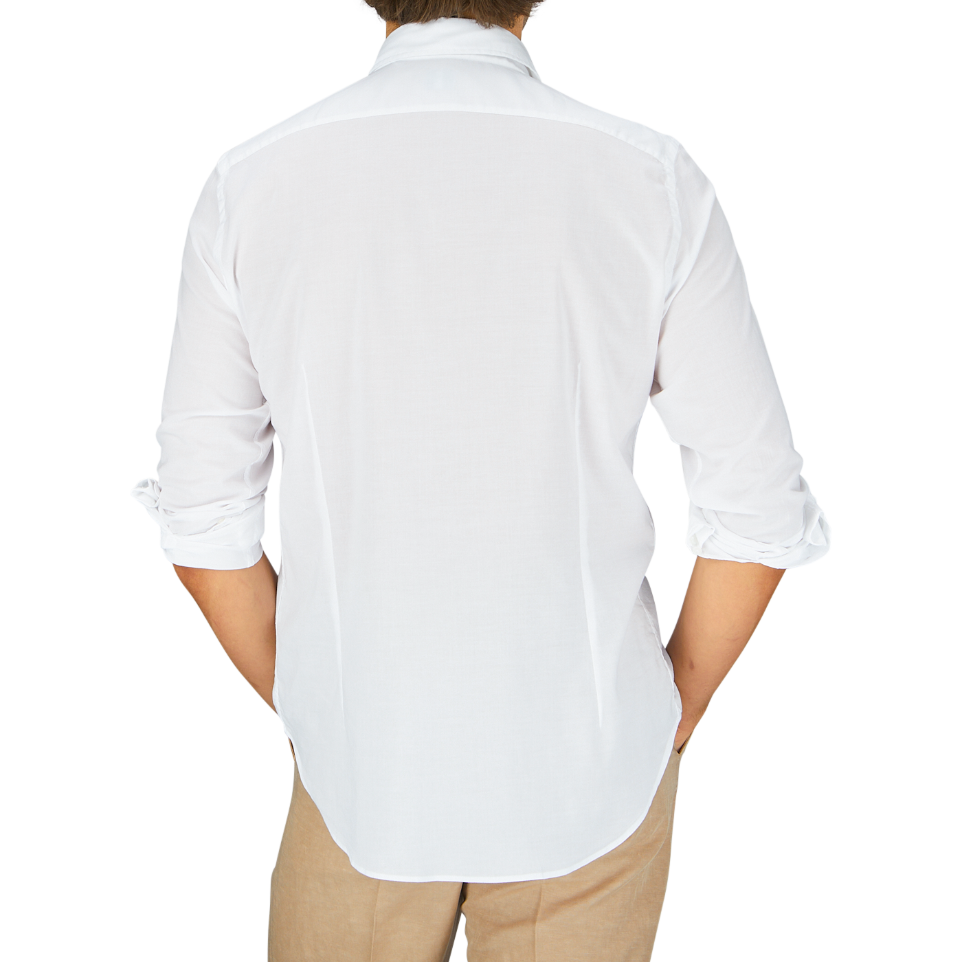 A person viewed from behind wearing a Fedeli white cotton-stretch beach shirt and beige trousers.