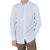 A man wearing a Finamore Light Blue Cotton Small Check BD Shirt and brown pants.
