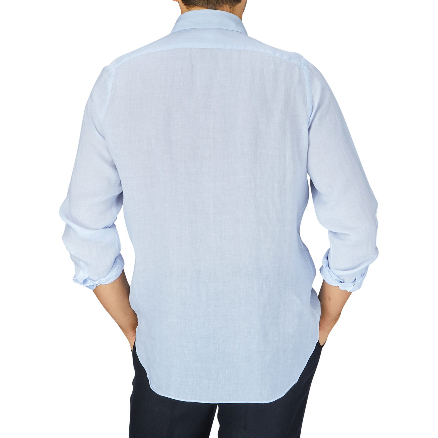 Man standing with his back to the camera, wearing a Finamore light blue linen casual shirt and dark trousers.