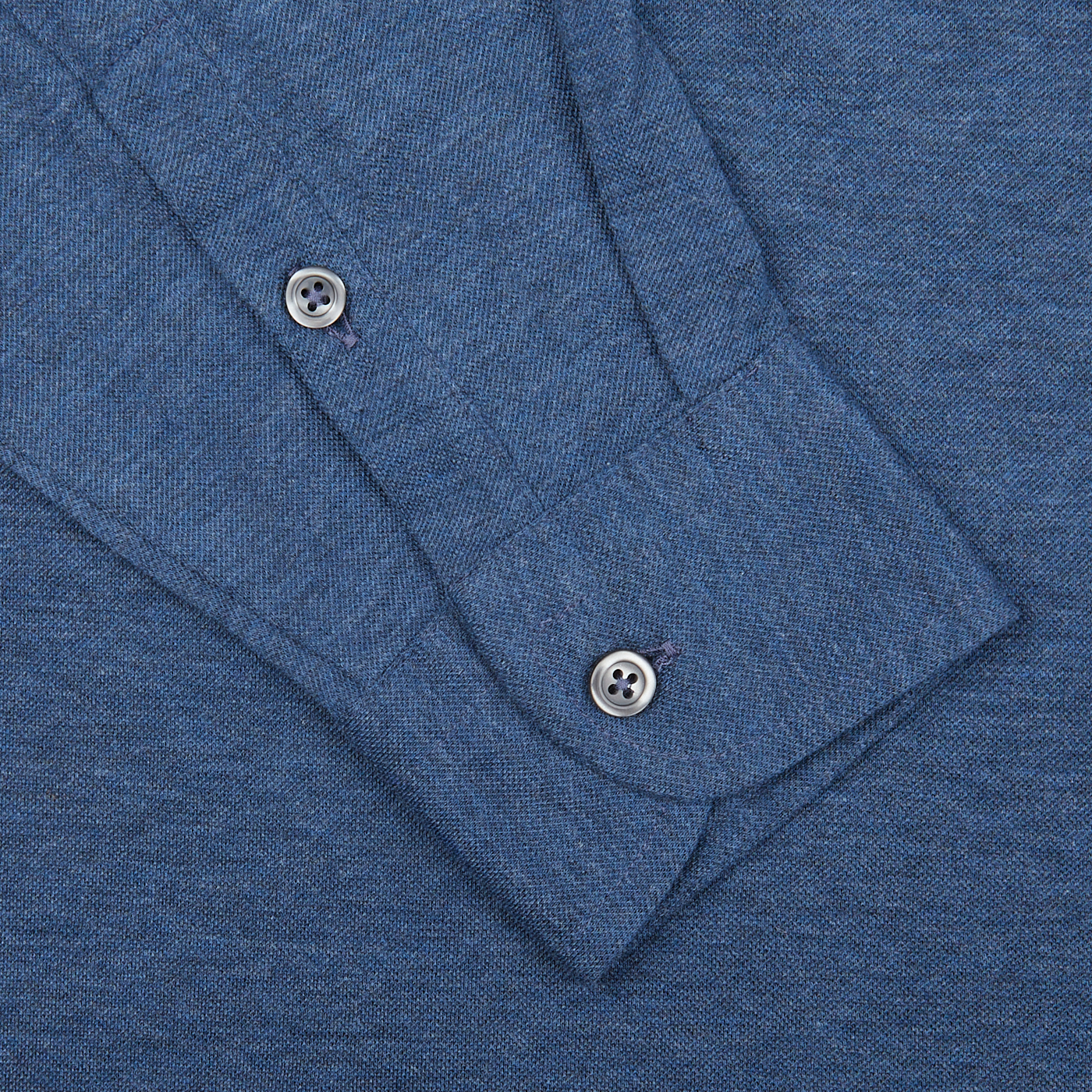Close-up of a Gran Sasso blue cotton jersey popover shirt collar with buttons.