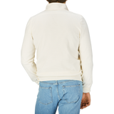 The back view of a man wearing a Gran Sasso Cream Beige Travel Wool Hybrid Jacket and jeans.