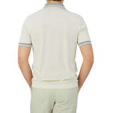 The back view of a man wearing a Gran Sasso Cream Beige Filo Scozia Zip Polo Shirt.