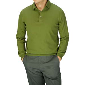 Man in a Gran Sasso Green Organic Cotton LS Polo Shirt and gray trousers against a light gray background.