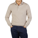 A man wearing a Light Beige Merino Wool One-Piece Collar Polo Shirt by Gran Sasso.
