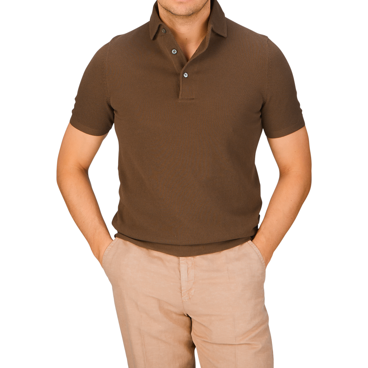 Man wearing a Gran Sasso Mid-Brown Fresh Cotton Mesh Polo Shirt and beige pants against a light blue background for improved breathability.