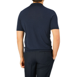 The back view of a man wearing a Gran Sasso Navy Blue Knitted Silk Polo Shirt.