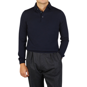 A man wearing a Gran Sasso Navy Merino Wool One-Piece Collar Polo Shirt and grey pants.