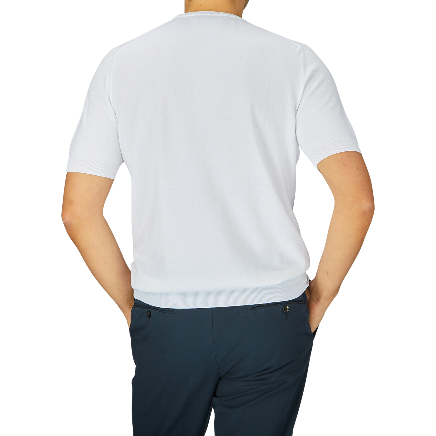 Rear view of a man wearing a Gran Sasso White Organic Cotton T-shirt and dark trousers, standing against a light gray background.