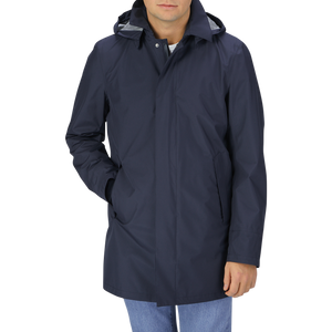 A man wearing a Navy Blue Nylon Laminar Car Coat by Herno with hood.