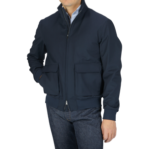 A man wearing a Navy Wool Loro Piana Storm System Blouson jacket and jeans.