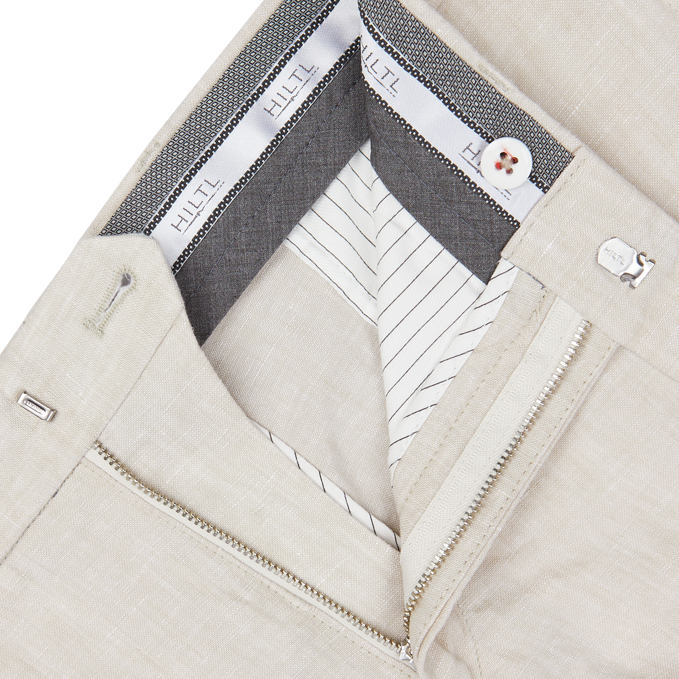 Close-up of a beige jacket with detailed inner lining, visible white shirt collar, and partial silver zipper paired with Hiltl Light Beige Washed Linen Regular Fit Chinos.