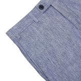 Close-up of a Hiltl Light Blue Washed Linen Regular Fit Chinos with a detailed view of the button and stitch work on a gray background.