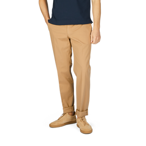 Man from waist down wearing beige Incotex Cotton Stretch Regular Fit chinos and beige boots, standing against a white background.