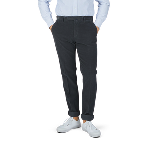A man in Grey Micro Cotton Corduroy High Comfort Chinos by Incotex is posing.