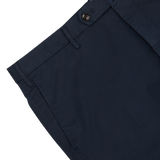 Close-up of Incotex navy blue cotton stretch regular fit chinos with visible button and belt loops on a light gray background.