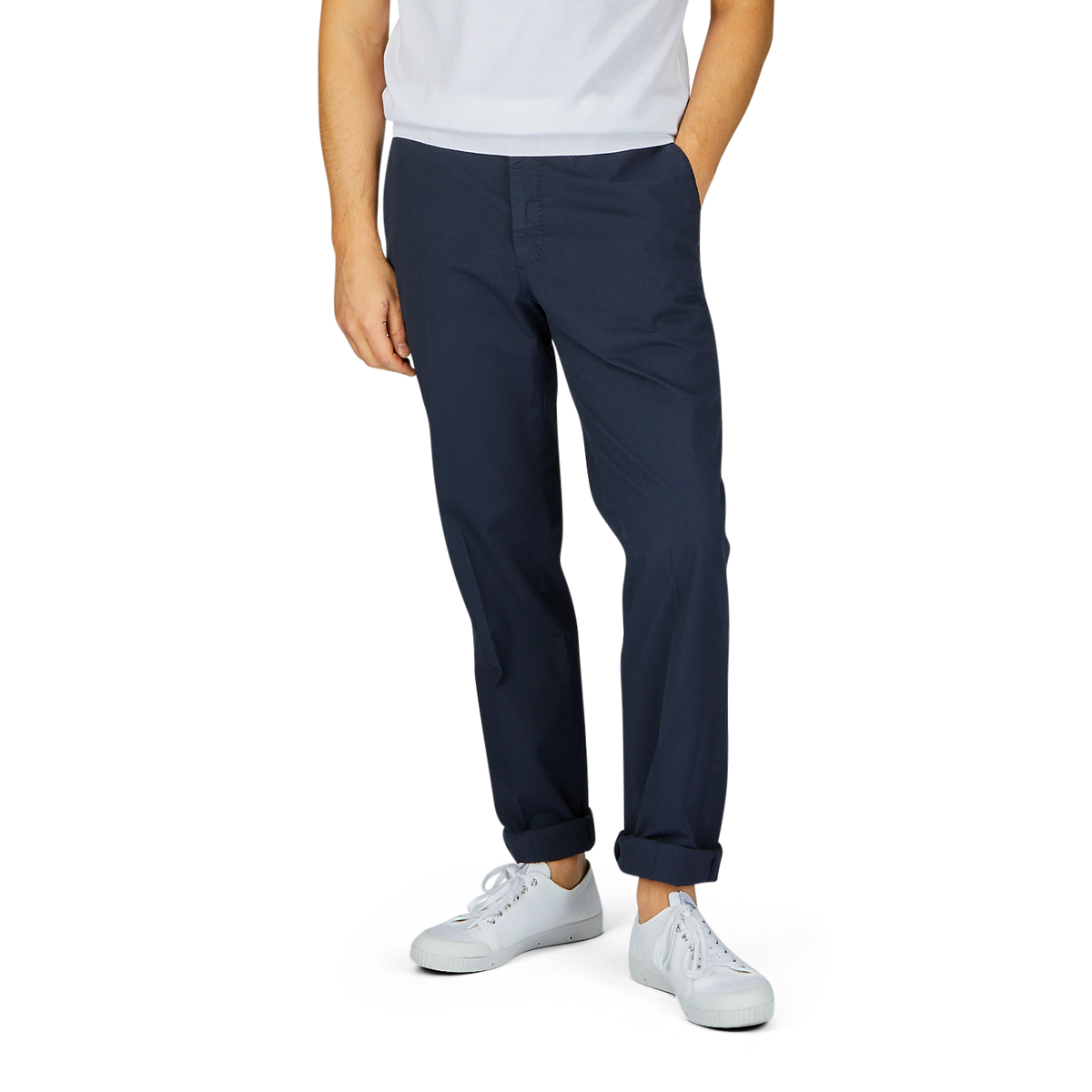 A person standing against a white background, wearing Incotex navy blue cotton stretch regular fit chinos and white sneakers.