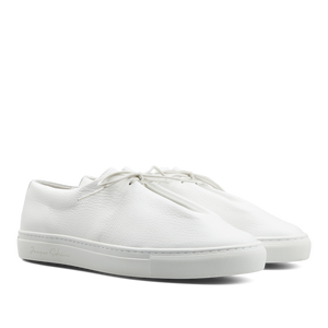 A pair of contemporary White Grained Leather Jim sneakers by Jacques Soloviére Paris on a white background.
