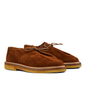 A pair of timeless Tobacco Brown Suede Leather Ray Derbies men's desert boots with laces on a plain background by Jacques Soloviére Paris.
