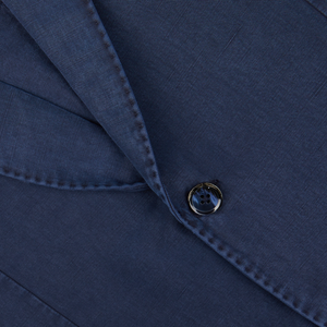 Close-up of a Navy Blue Washed Cotton Linen Blazer fabric with a button, likely showcasing exquisite Italian tailoring by L.B.M. 1911.