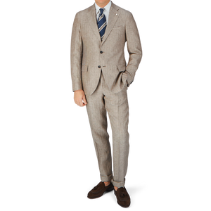 A man is posing in a Luigi Bianchi Light Brown Herringbone Linen Suit.