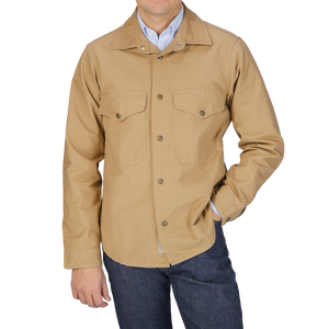 A man wearing a Camel Beige Cotton Ripstop Country Overshirt by Manifattura Ceccarelli and jeans.