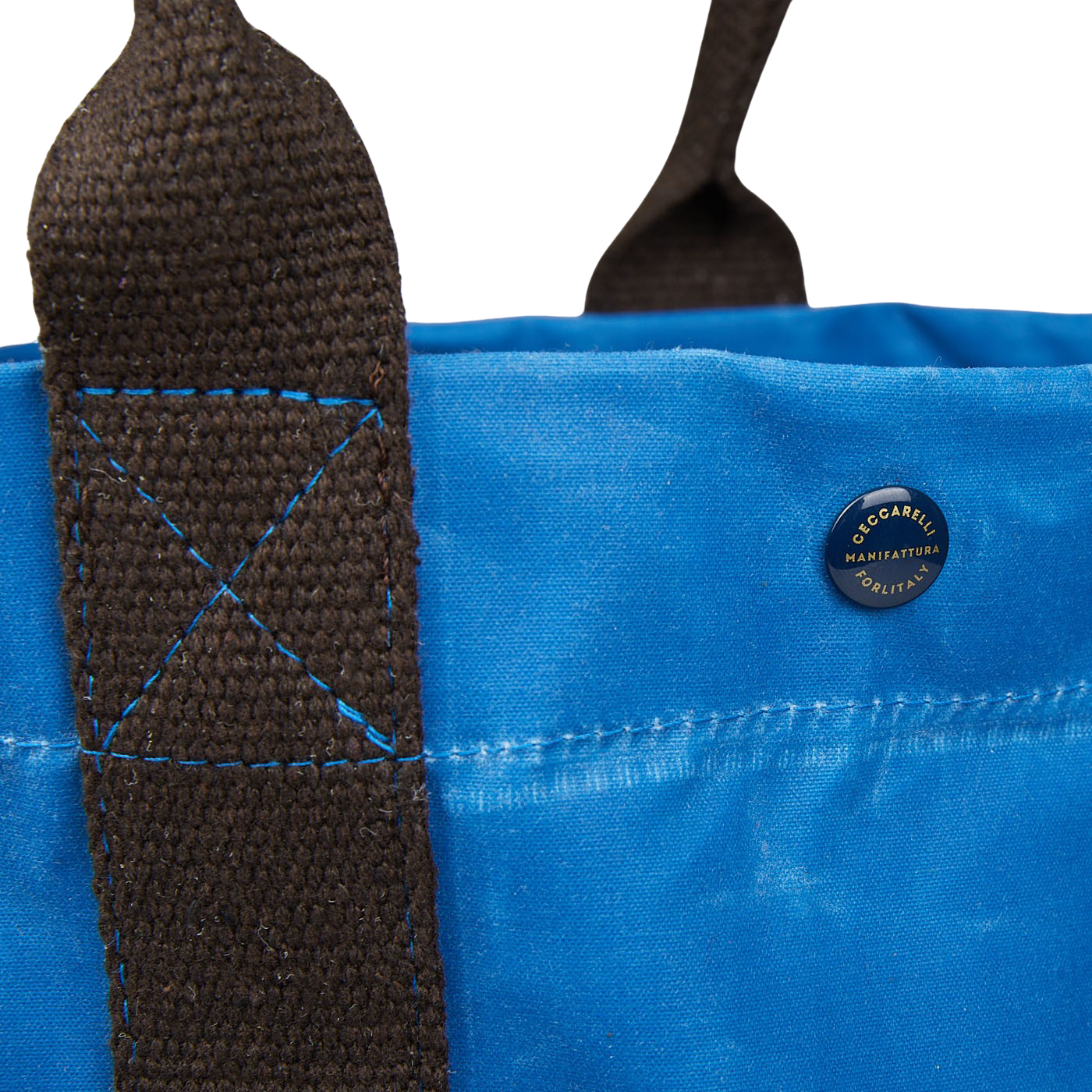 A close up of a Manifattura Ceccarelli jeans blue waxed cotton tote bag.