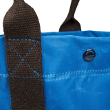 A close up of a Manifattura Ceccarelli jeans blue waxed cotton tote bag.