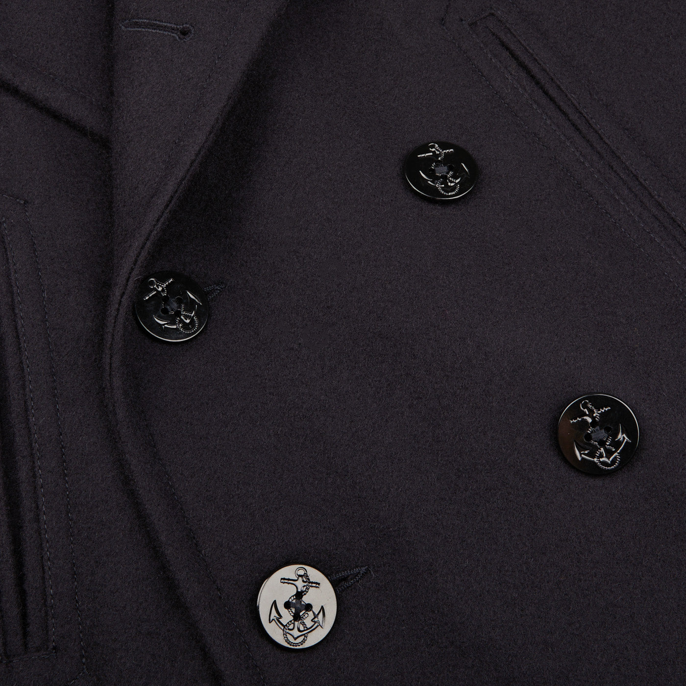 A close up image of a navy blue Manifattura Ceccarelli Navy Blue Heavy Wool Casentino Peacoat with buttons.
