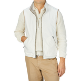 A man wearing a Beige Reversible Loro Piana Cashpima Gilet and tan pants by Manto.