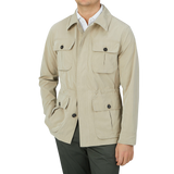 A man wearing a Manto Khaki Beige Ultrafine Microfiber Safari Jacket, which is wind and water-resistant.