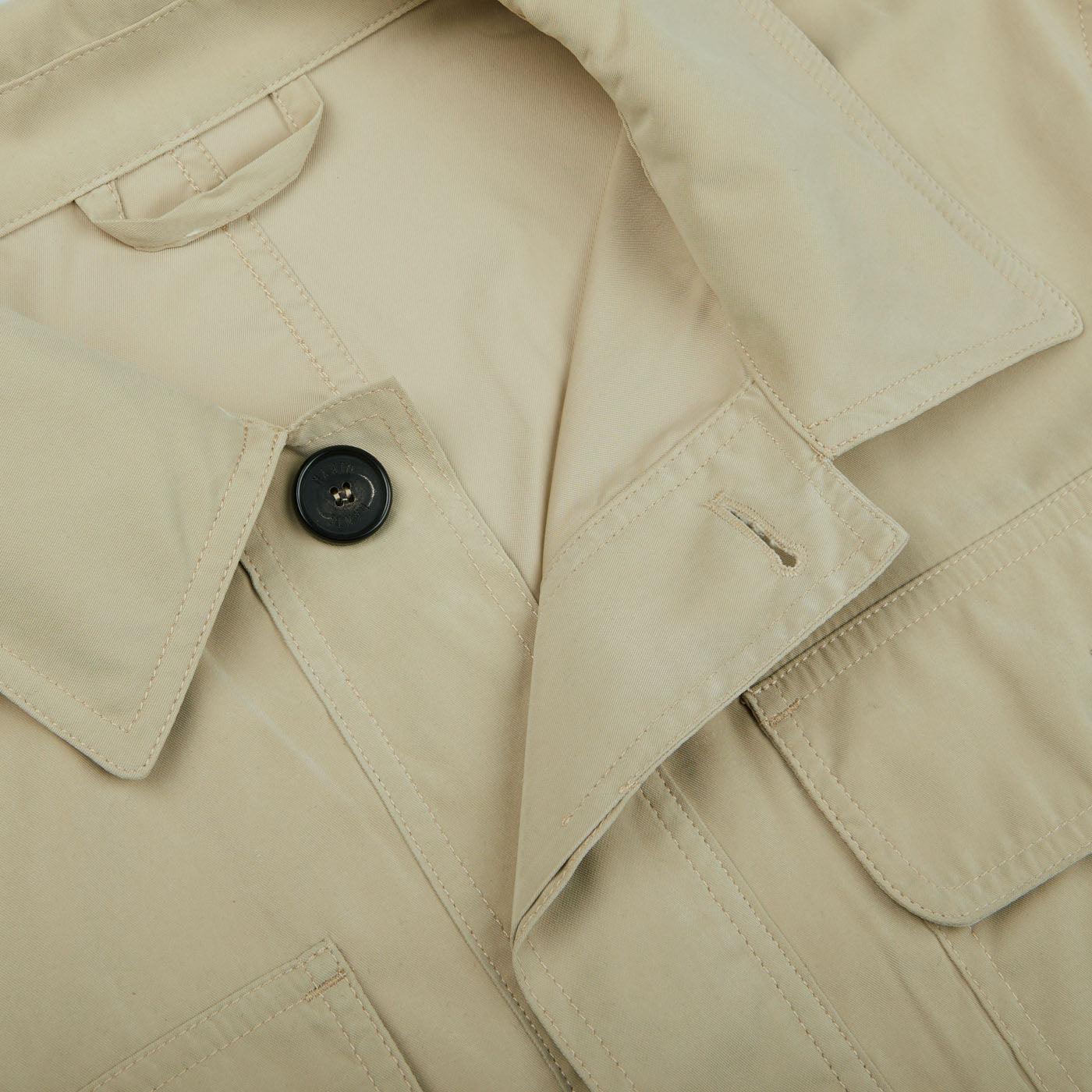 A close-up of a Khaki Beige Ultrafine Microfiber Safari Jacket with buttons, made by Manto.