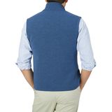 The back view of a man wearing a Maurizio Baldassari Denim Blue Milano Stitch Wool Zip Gilet.
