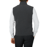 The back view of a man wearing a Maurizio Baldassari Charcoal Grey Milano Stitch Wool Zip Gilet.