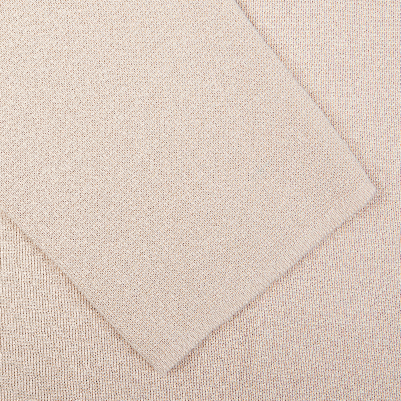 Close-up view of two textured fabric samples overlapping each other, one being a silk-cotton blend in the Maurizio Baldassari Light Beige Silk Cotton Knitted Milano Blazer.