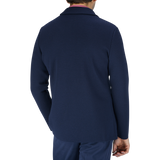 The back view of a man wearing a Maurizio Baldassari Navy Blue Merino Wool Milano Stitch Swacket and pants crafted from merino wool.