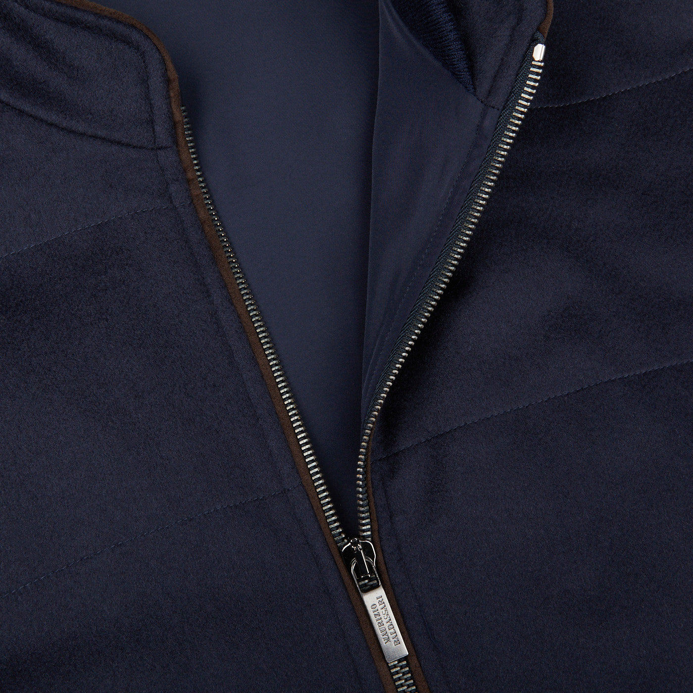 A close up of a Maurizio Baldassari Navy Water Repellent Pure Cashmere Gilet with zippers.