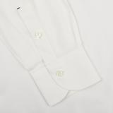 Close-up of a Mazzarelli Off White Cotton Twill BD Slim Shirt cuff with two buttons, showcasing detailed stitching and fabric texture.