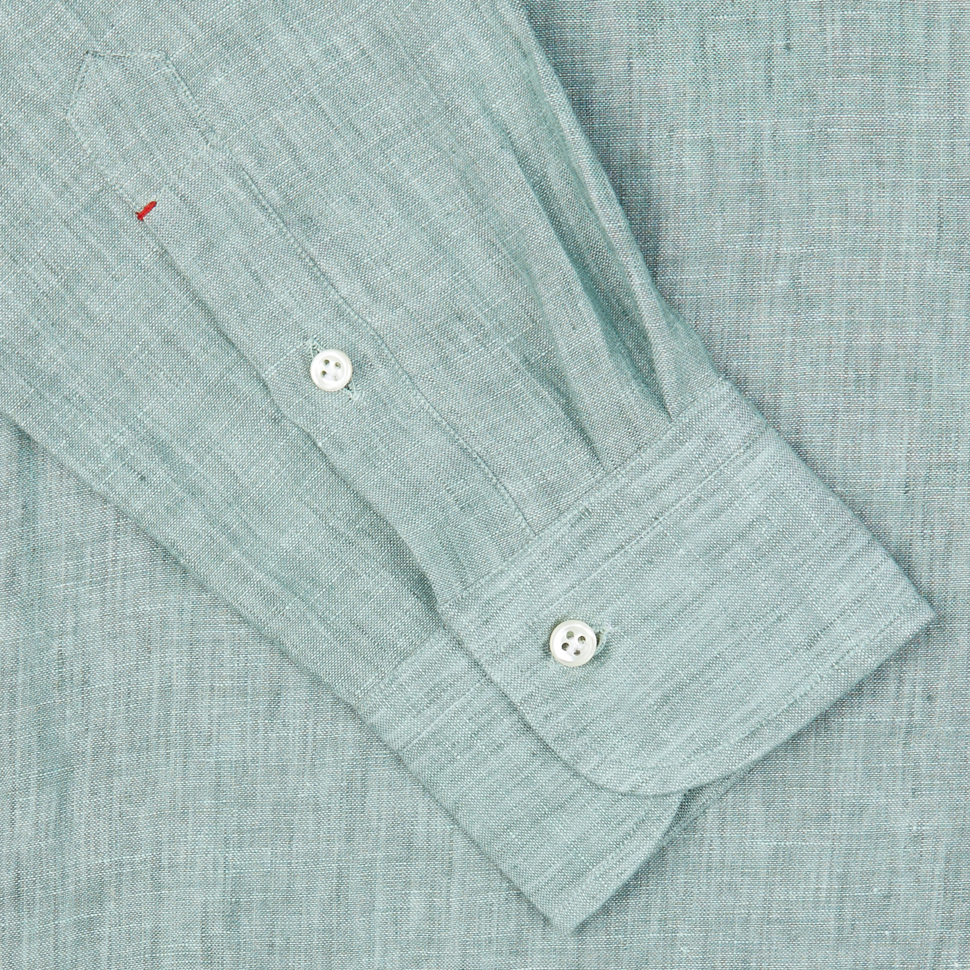 Close-up of a Mazzarelli Teal Green Organic Linen BD Slim Shirt's cuff with two white buttons.