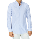 A person wearing a White Blue Bengal Striped BD Slim Shirt by Mazzarelli with a soft button-down collar and white pants.