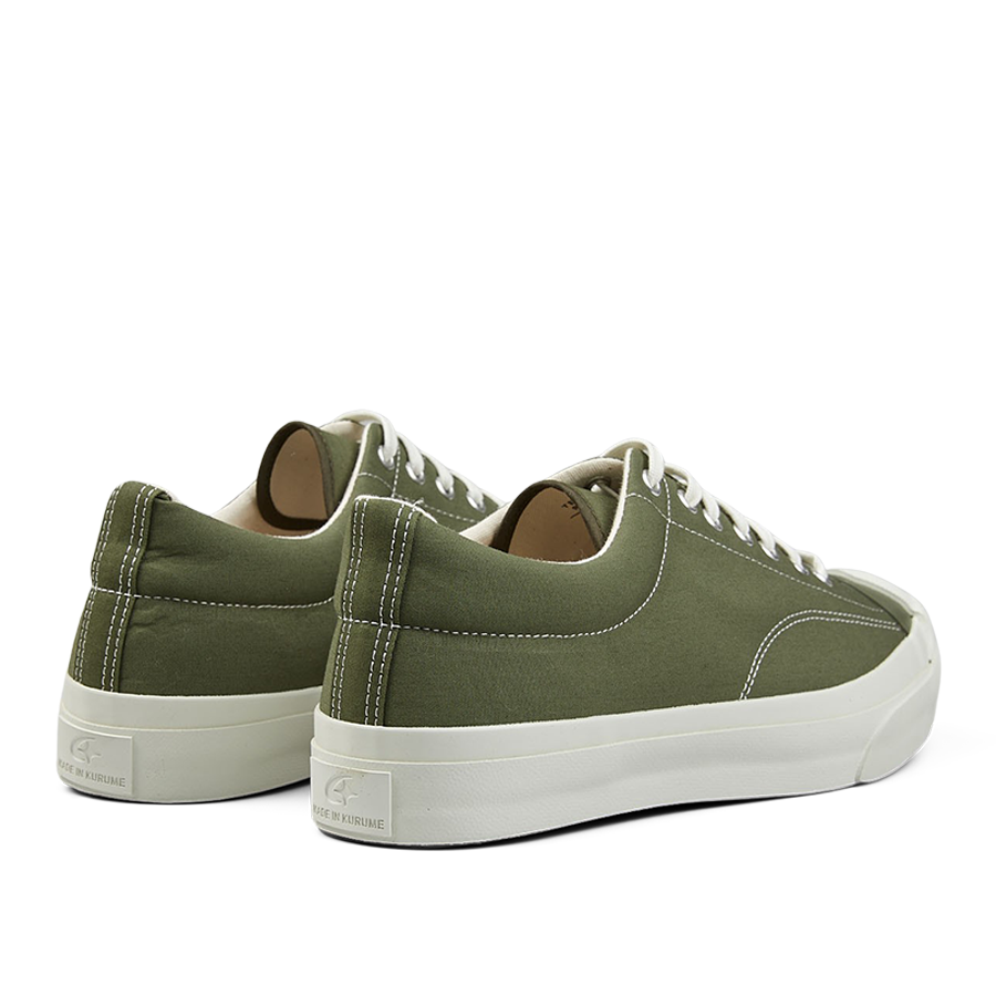 A pair of olive green nylon Moonstar gym court sneakers with white laces and rubber soles.