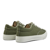 A pair of olive green nylon Moonstar gym court sneakers with white laces and rubber soles.