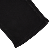 Black Shadow Cotton Transcend Normandie Jeans by Paige with a hem on a white background.