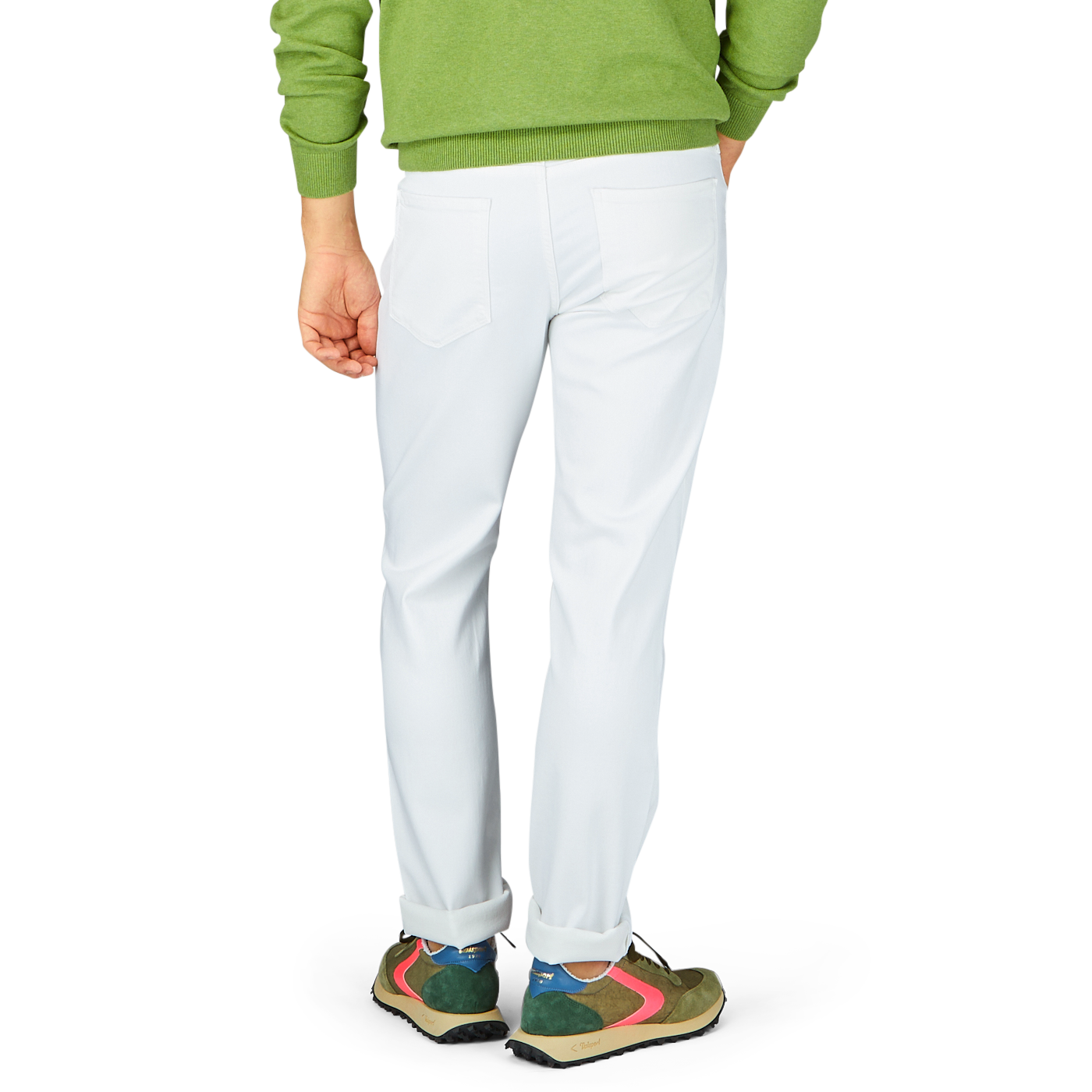 Person wearing white Paige Icecap White Cotton Transcend Federal Slim Jeans and colorful sneakers standing against a neutral background.